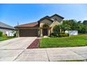 Charming home featuring a two-car garage, manicured lawn, and well-maintained landscaping at 1704 Via Palermo St, Plant City, FL 33566