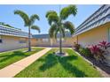 The exterior shows manicured lawns and palm trees, enhancing the curb appeal of this welcoming community at 1802 Bedford Ter # 187, Sun City Center, FL 33573