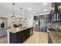 Modern kitchen features a large island, granite countertops, and stainless steel appliances at 18796 Obregan Dr, Spring Hill, FL 34610