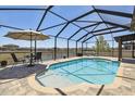 Inviting screened-in pool area with comfortable seating and serene lake views at 18796 Obregan Dr, Spring Hill, FL 34610