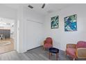 Cozy sitting area with two chairs, leaf paintings and a closet by the entrance at 20121 Bending Creek Pl, Tampa, FL 33647