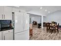 Open concept kitchen with white cabinets and stainless steel appliances at 2366 Covington Dr, Clearwater, FL 33763