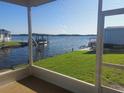 Relaxing screened-in porch with scenic water views, including a boat dock and lush green lawn at 267 Colonial Blvd # 9, Palm Harbor, FL 34684
