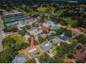 Beautiful aerial view of a home with a golf course, community pool, and tennis courts nearby at 2700 Westchester N Dr, Clearwater, FL 33761