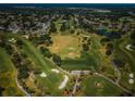 Scenic aerial view of a lush golf course featuring manicured greens, water hazards, and tree-lined fairways at 2700 Westchester N Dr, Clearwater, FL 33761