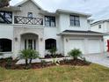 Beautiful two-story home featuring brick accents, balcony, arched entryway, and attached two-car garage at 3910 W San Carlos St, Tampa, FL 33629