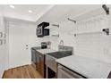 Modern kitchen featuring subway tile, open shelving, stainless steel appliances, and hardwood floors at 404 Danube Ave, Tampa, FL 33606