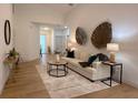 Inviting living room with neutral tones, decorative accents, and wood-look floors at 5105 68Th N Way, St Petersburg, FL 33709