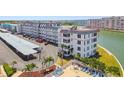 A white condo complex features a pool with water views, as indicated by the red outline at 5960 30Th S Ave # 414, Gulfport, FL 33707