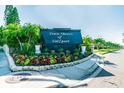 Town Shores of Gulfport sign surrounded by colorful, manicured landscaping at 5960 30Th S Ave # 414, Gulfport, FL 33707
