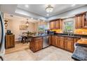 Well-lit kitchen showcasing custom cabinetry, granite countertops, stainless steel appliances, and tile flooring at 6821 Mary Lou Ln, Wesley Chapel, FL 33544
