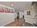 Inviting hallway featuring wood floors, bright lighting, and stylish decor at 6822 Kissimmee St # 8-B, Tampa, FL 33616