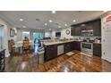 Open-concept kitchen featuring stainless steel appliances and a seamless flow to the living area at 6822 Kissimmee St # 8-B, Tampa, FL 33616