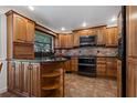 Well-equipped kitchen featuring custom wood cabinetry and modern appliances at 785 Hickory Ln, Palm Harbor, FL 34683