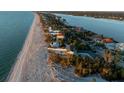 Stunning aerial view of beachfront homes along the coast with lush tropical landscaping at 8030 Manasota Key Rd, Englewood, FL 34223