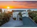 Stunning beachfront home with a beautiful sunset view and lush tropical landscaping at 8030 Manasota Key Rd, Englewood, FL 34223