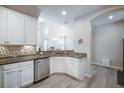 Open kitchen with stainless steel appliances, granite countertops, and white cabinets at 10742 Verawood Dr, Riverview, FL 33579