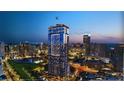 Stunning exterior elevation of a modern high rise with a helicopter on the roof in a bustling cityscape at 1101 E Jackson St # 3805, Tampa, FL 33602