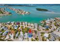 Stunning aerial view of a waterfront property surrounded by beautiful blue waters and lush green landscapes at 13117 4Th E St, Madeira Beach, FL 33708