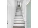 Contemporary stairway with white risers, wood treads and white railings at 13117 4Th E St, Madeira Beach, FL 33708