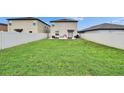 Expansive backyard with lush lawn, perfect for outdoor activities and entertaining at 15718 Fort Island Pl, Sun City Center, FL 33573