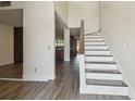 Inviting home entryway with hardwood floors, a staircase, and an open view into the kitchen at 16169 Gardendale Dr, Tampa, FL 33624