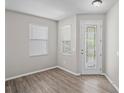 Bright entryway features modern floors, a decorative glass door, and natural light from two windows at 18837 Litzau Ln, Land O Lakes, FL 34638