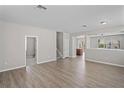 Spacious living room with wood-look floors and a view of the staircase at 18837 Litzau Ln, Land O Lakes, FL 34638