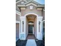 Welcoming front door entrance with decorative sidelights and a charming welcome sign at 19610 Sunset Bay Dr, Land O Lakes, FL 34638