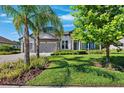 Charming two-story home with well-maintained lawn, lush landscaping, and a three-car garage at 2817 Cordoba Ranch Blvd, Lutz, FL 33559