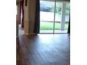 Living area with wood flooring, sliding glass doors with view to outdoor space at 30434 Colehaven Ct, Wesley Chapel, FL 33543
