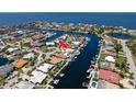 Aerial view of waterfront community showcasing prime real estate and boating access to open waters, canals, and nearby waterways at 3235 Seaway Dr, New Port Richey, FL 34652