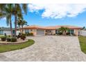 Well maintained single-Gathering home with a spacious paved driveway, mature landscaping, and a beautiful, bright coral-colored tiled roof at 3235 Seaway Dr, New Port Richey, FL 34652