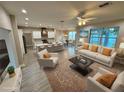 A spacious living room seamlessly flows into a modern kitchen with a large island and bar seating at 37565 Teri Ct, Dade City, FL 33525
