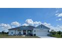 Charming one-story home with blue and gray exterior paint and well-manicured lawn at 4294 Cork Rd, Plant City, FL 33565