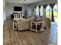 Spacious living room with hardwood floors, lots of natural light, and comfortable seating at 4294 Cork Rd, Plant City, FL 33565