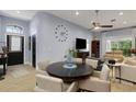 Open-concept living area with a TV, wood-look flooring, and comfortable seating arrangements at 4425 Connery Ct, Palm Harbor, FL 34685