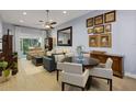 Bright living room with neutral furniture, wood-look flooring, and access to a sliding glass door at 4425 Connery Ct, Palm Harbor, FL 34685