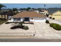 Charming single-story home boasts a well-maintained yard with decorative landscaping and a two-car garage at 6528 Santiago Ct, Apollo Beach, FL 33572