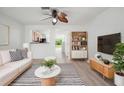 Bright living room with modern decor, ceiling fan, luxury vinyl plank flooring, and plenty of natural light at 6831 Dartmouth Hill St, Riverview, FL 33578