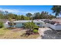 Single-story home featuring a spacious driveway and a neatly landscaped front yard at 736 85Th N Ave, St Petersburg, FL 33702