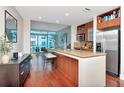 Modern kitchen with granite countertops, stainless steel appliances and island seating at 912 Channelside Dr # 2710, Tampa, FL 33602