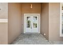 Elegant double front doors with glass panels and a classic exterior light fixture at 9127 Irondale Ln, Hudson, FL 34667