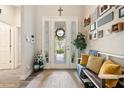 Inviting foyer with a decorative front door, coat rack, and neutral decor at 922 Grand Cresta Ave, Brandon, FL 33511