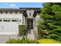 Close up of the front entrance with stone accents and lush landscaping at 922 Grand Cresta Ave, Brandon, FL 33511