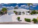 Charming home featuring a well-manicured, low maintenance yard, a two-car garage, and decorative gated entry at 927 Golf Island Dr, Apollo Beach, FL 33572