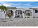 Close up of home featuring an attractive gated entry with decorative ironwork and an inviting walkway at 927 Golf Island Dr, Apollo Beach, FL 33572