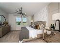 Serene main bedroom with decorative wall accents, plush bedding, and ample natural light at 10006 Surrey Rose Dr, San Antonio, FL 33576