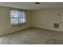 Well-lit living room features lots of natural light and neutral colored walls at 10817 Fillmore Ave, Port Richey, FL 34668