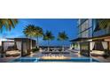 Luxury outdoor pool and lounge area with cabanas, lounge chairs, and fire pit at 1101 E Jackson St # 1921, Tampa, FL 33602